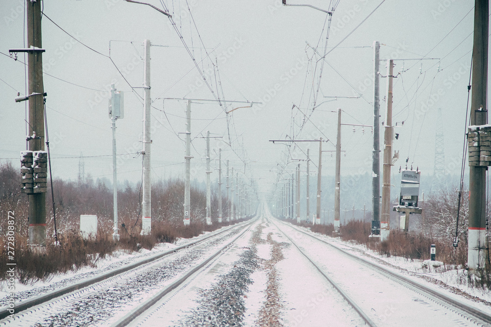 Winter Russian Railway. Public transport. winter road. Rails and sleepers. Electricity
