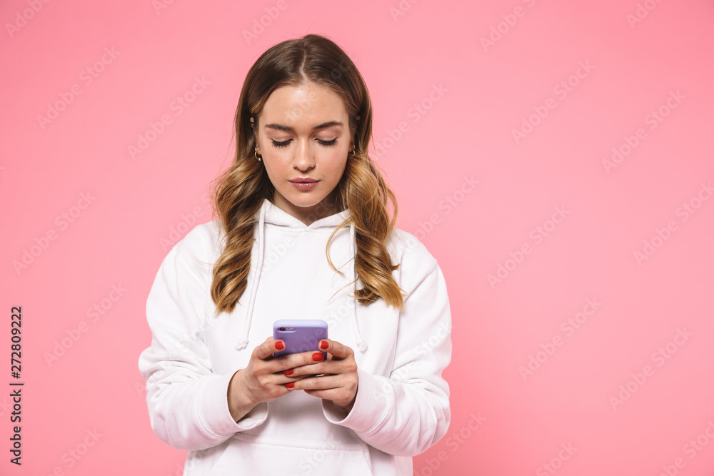 Calm blonde woman wearing in casual clothes using smartphone