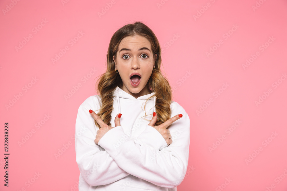 Surprised woman wearing in casual clothes pointing to the sides Surprised woman wearing in casual clothes pointing to the sides