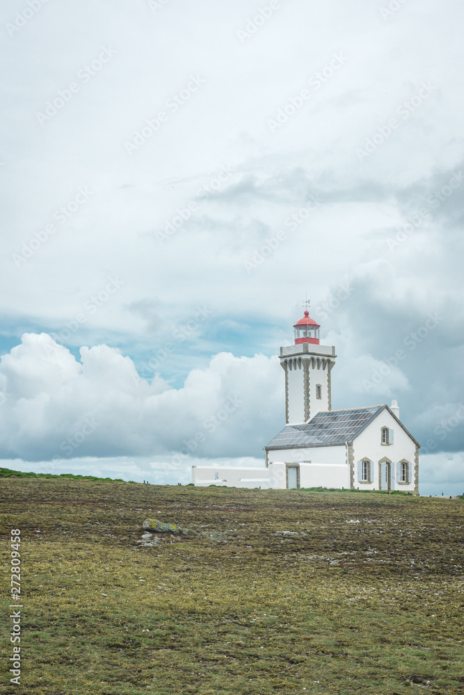 Lighthouse under threatening sky in Brittany, France Lighthouse under threatening sky in Brittany, France