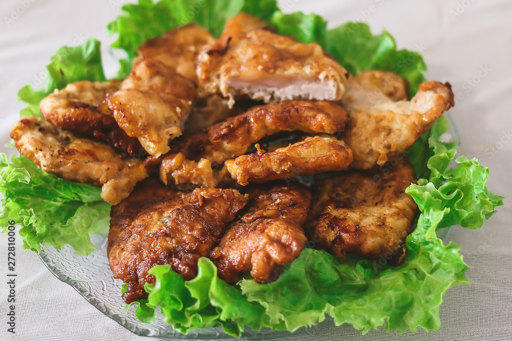 homemade grilled chops with lettuce leaves on the kitchen table. homemade grilled chops with lettuce leaves on the kitchen table.