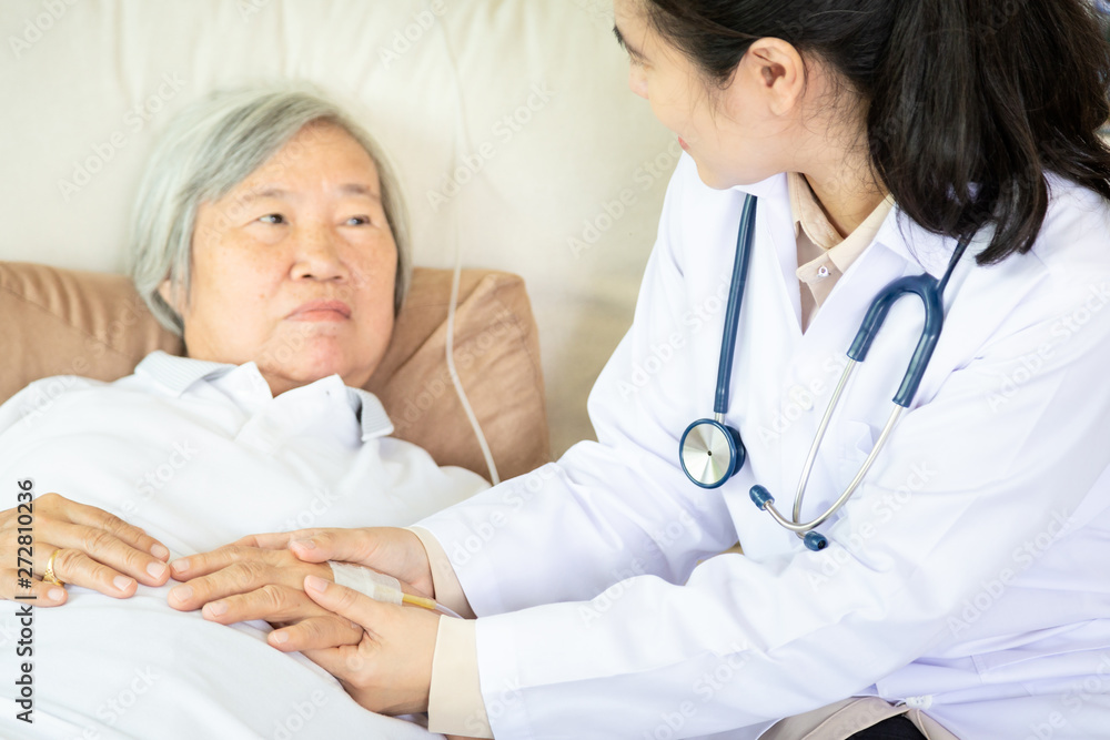 Medical female doctor or nurse holding senior patient hands and comforting her at hospital ,hand of elderly woman with fluid replacement therapy for patient or saline intravenous,support,care concept Medical female doctor or nurse holding senior patient hands and comforting her at hospital ,hand of elderly woman with fluid replacement therapy for patient or saline intravenous,support,care concept
