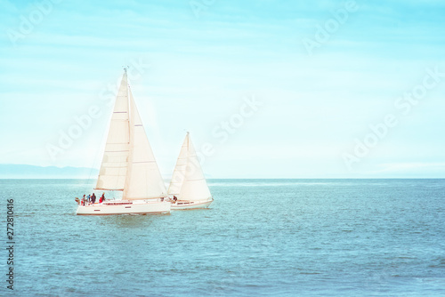 Scenic abstract sea landscape panorama background with two racing sailboats or yachts on sunny day. Sail boats sailing the Pacific Ocean, at Santa Barbara beach, California, USA.