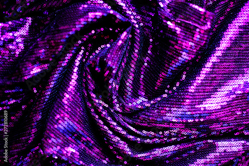 Cloth with neon purple paillettes. Background texture, new year and holiday