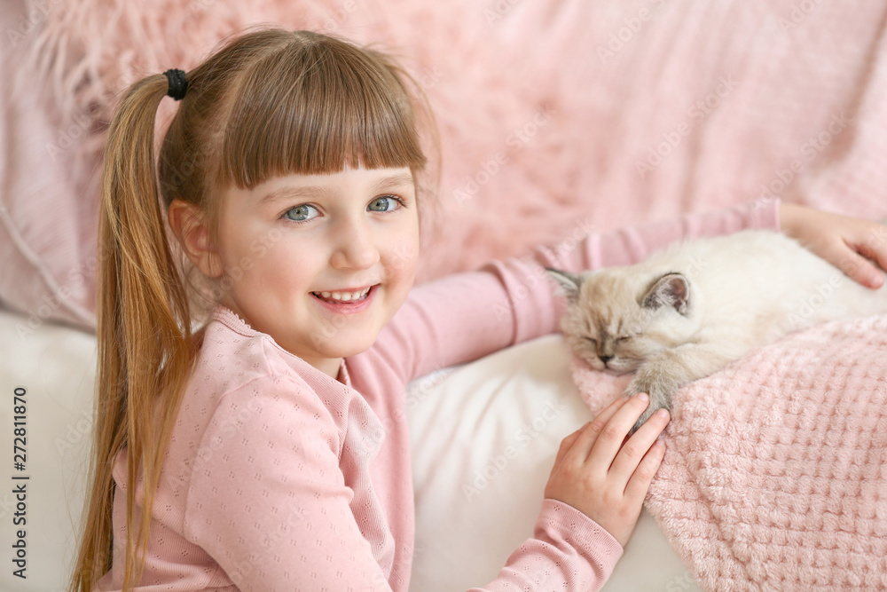 Girl with cute fluffy kitten at home Girl with cute fluffy kitten at home