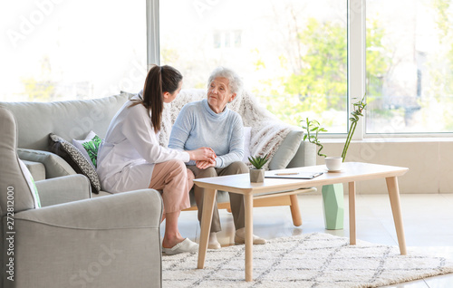 Fototapeta Doctor with senior woman in nursing home