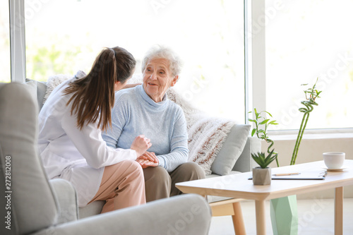 Doctor with senior woman in nursing home
