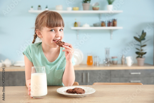 Cute little girl with glass...