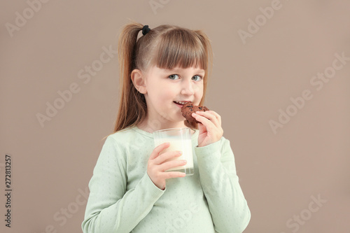 Cute little girl with glass...