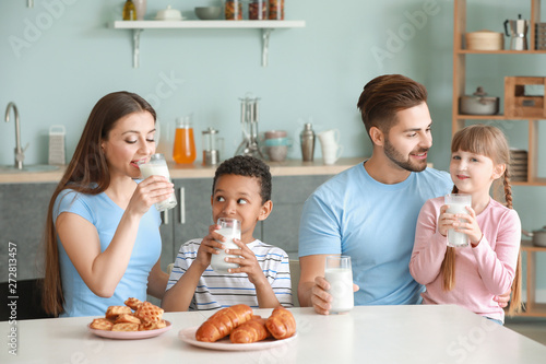 Young family drinking tasty...