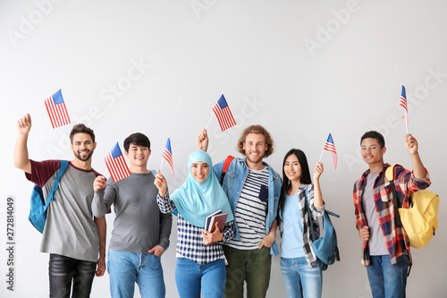 Group of students with USA flags on light background photo
