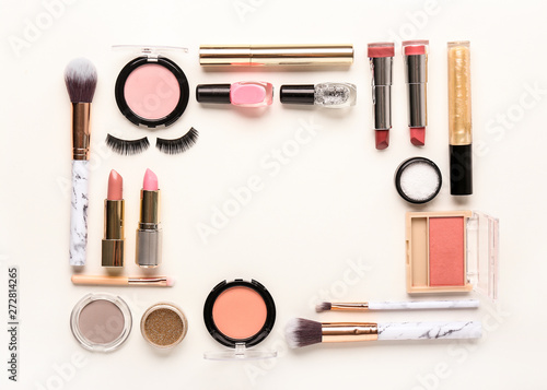 Frame made of decorative cosmetics on white background