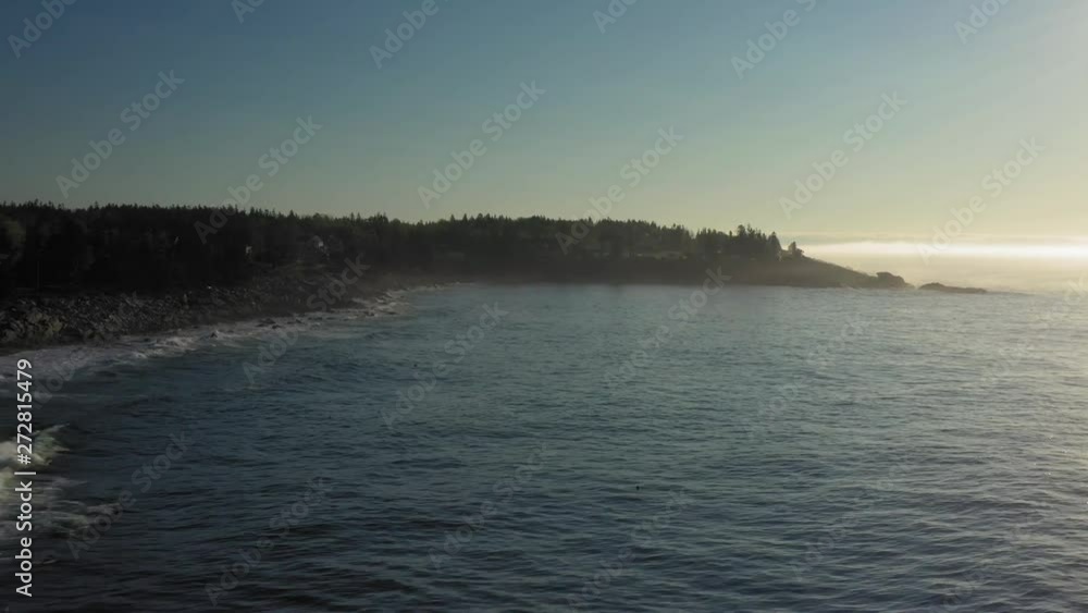 Flying along Maine's rocky coast during a misty morning sunrise AERIAL Flying along Maine's rocky coast during a misty morning sunrise AERIAL