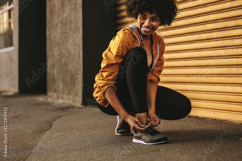 Runner tying shoe laces