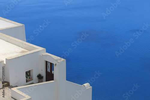 Spectacular sea view with white traditional cycladic building. Big blue space for text. Perfect background for all purpose prints. Santorini oia fira caldera view.