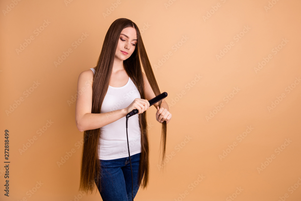 Close up photo beautiful amazing her she lady arms hands hold very long hair curl straightening enjoy easy simple process wear casual white tank-top jeans denim isolated pastel beige background Close up photo beautiful amazing her she lady arms hands hold very long hair curl straightening enjoy easy simple process wear casual white tank-top jeans denim isolated pastel beige background