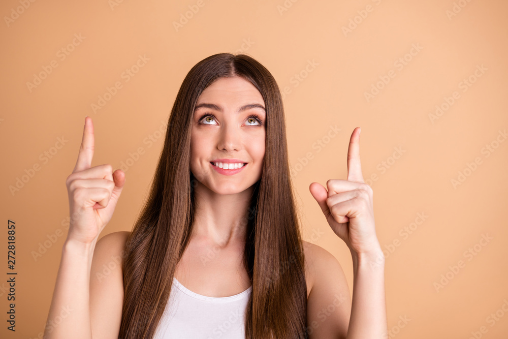 Portrait of cute charming nice teen teenager look up have promotion choice decision ads wear white singlet top isolated beige background pastel Portrait of cute charming nice teen teenager look up have promotion choice decision ads wear white singlet top isolated beige background pastel