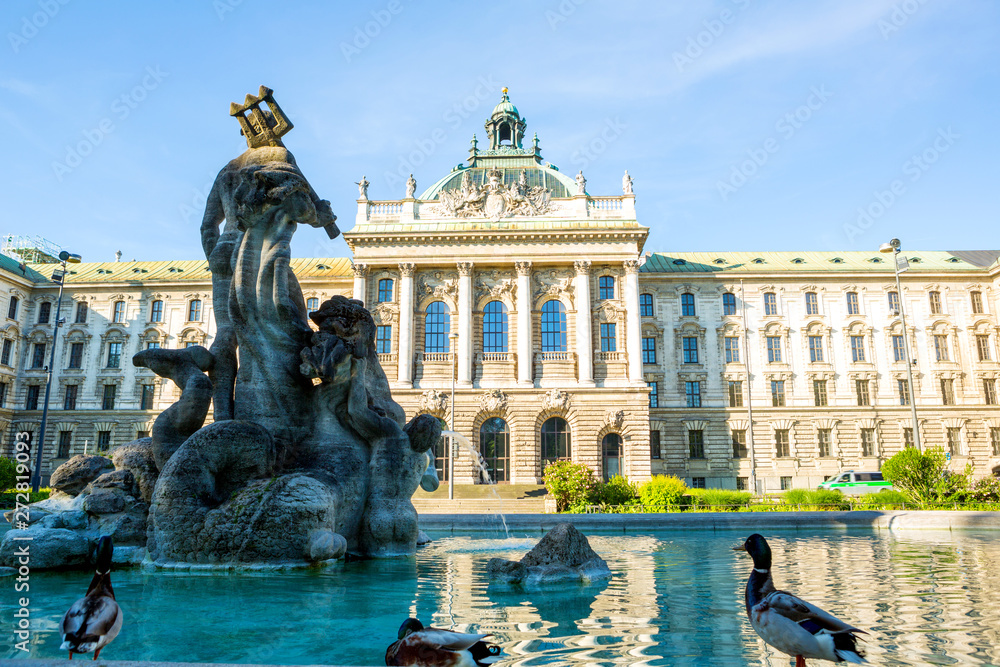 Fototapeta premium Ministry of Justice of Bavaria Building with Neptunbrunnen fountain in Munich