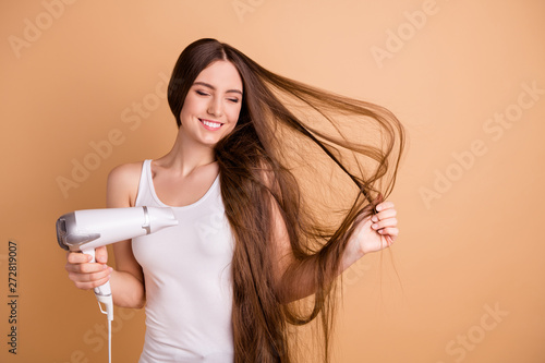 Portrait of charming nice lovely youth have hold hand equipment dry hairstyle close eyes feel satisfied content isolated wear white stylish clothing light-colored beige pastel background