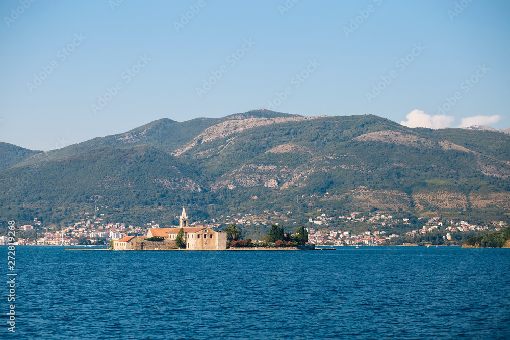Adriatic Sea, Montenegro. View of a small church on the island of St. George in the Bay of Kotor, view from a boat, Montenegro. Place for text.