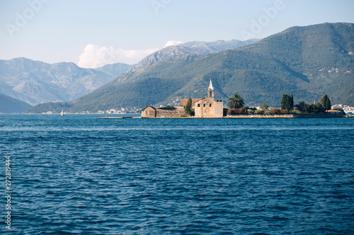 Adriatic Sea, Montenegro. View of a small church on the island of St. George in the Bay of Kotor, view from a boat, Montenegro. Place for text.