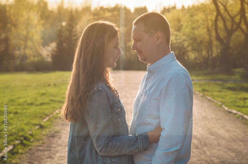 Fototapeta premium A young couple spends time together outdoors. Couple having fun summer time