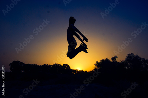 silhouette of man jumping on background of sky
