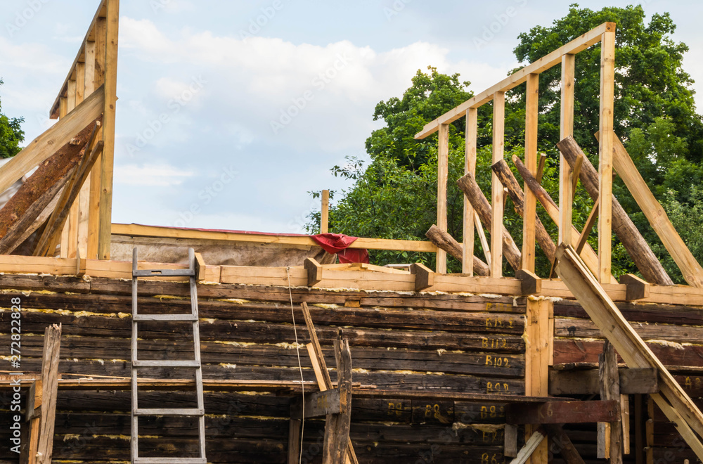 Installation of a new wooden roof on a dwelling house by a team of joiners and roofers Installation of a new wooden roof on a dwelling house by a team of joiners and roofers