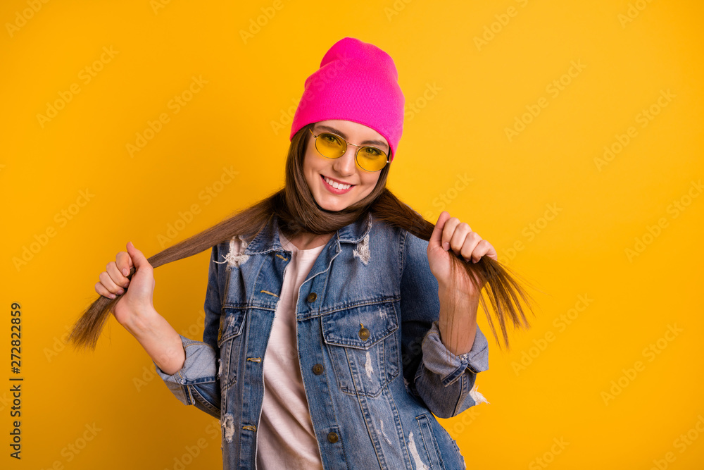 Close up photo beautiful amazing she her lady stylish hold hands arms very long curls hairstyle straight crossing around neck wear specs casual jeans denim jacket pink hat isolated yellow background Close up photo beautiful amazing she her lady stylish hold hands arms very long curls hairstyle straight crossing around neck wear specs casual jeans denim jacket pink hat isolated yellow background