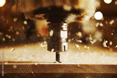 Close-up shot of machine with numerical control cuts wood. Cnc tool. photo