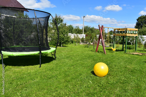 Trampoline with yellow fitbull. photo