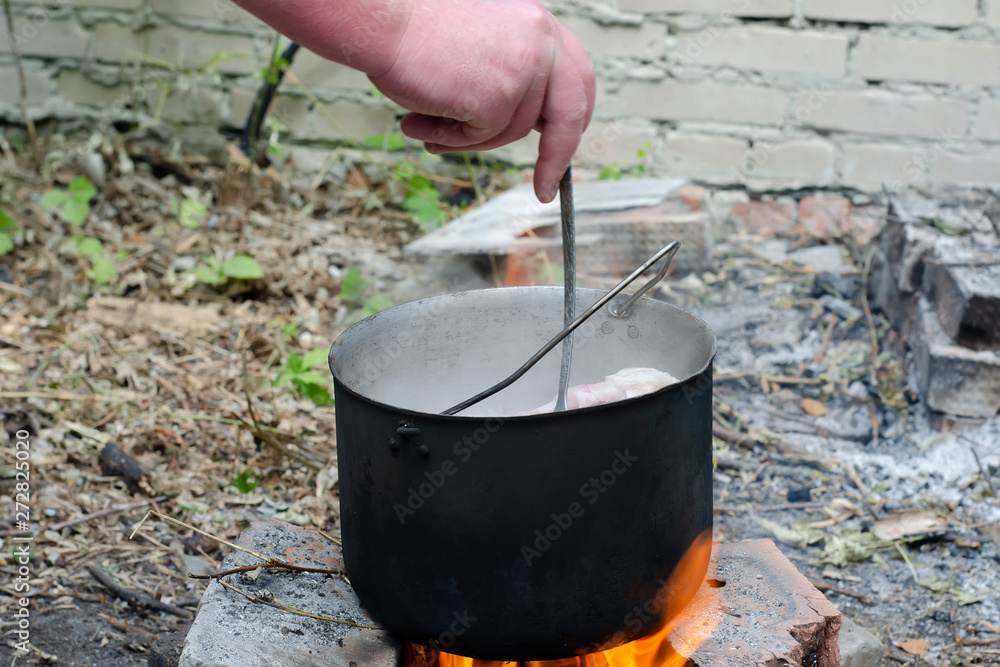 cooked soup in a cauldron on open fire cooked soup in a cauldron on open fire