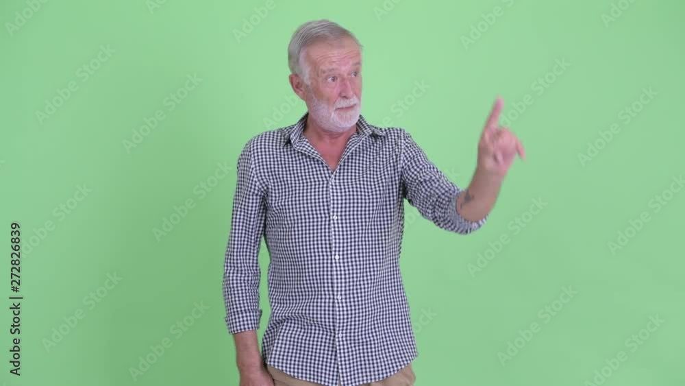 Happy senior bearded man presenting and touching something Happy senior bearded man presenting and touching something