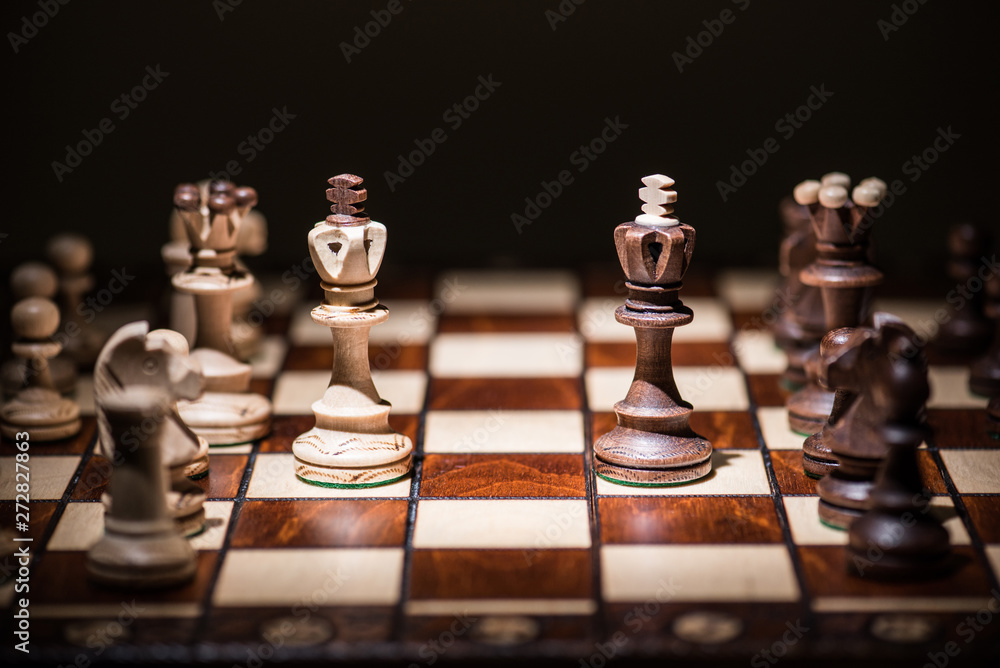 black against white king chess pieces on chess board black against white king chess pieces on chess board