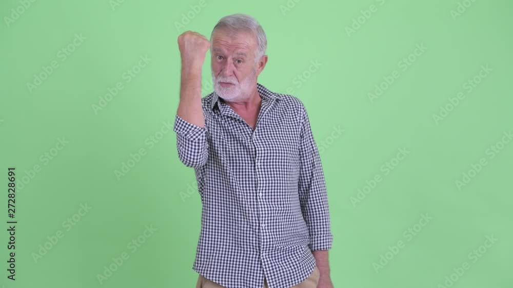 Happy senior bearded man with fist raised Happy senior bearded man with fist raised