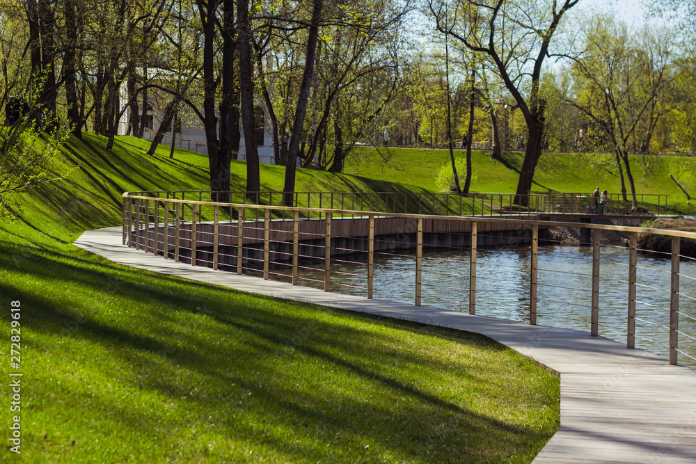 beautiful park in summer. wooden lakeside promenade, a place for outdoor recreation