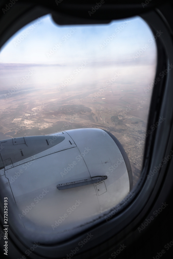 View from the airplane window on the river below. Tourist route to warm countries. The theme of the travel agency. Stock photo