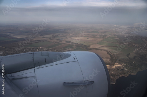 View from the airplane window on the river below. Tourist route to warm countries. The theme of the travel agency. Stock photo