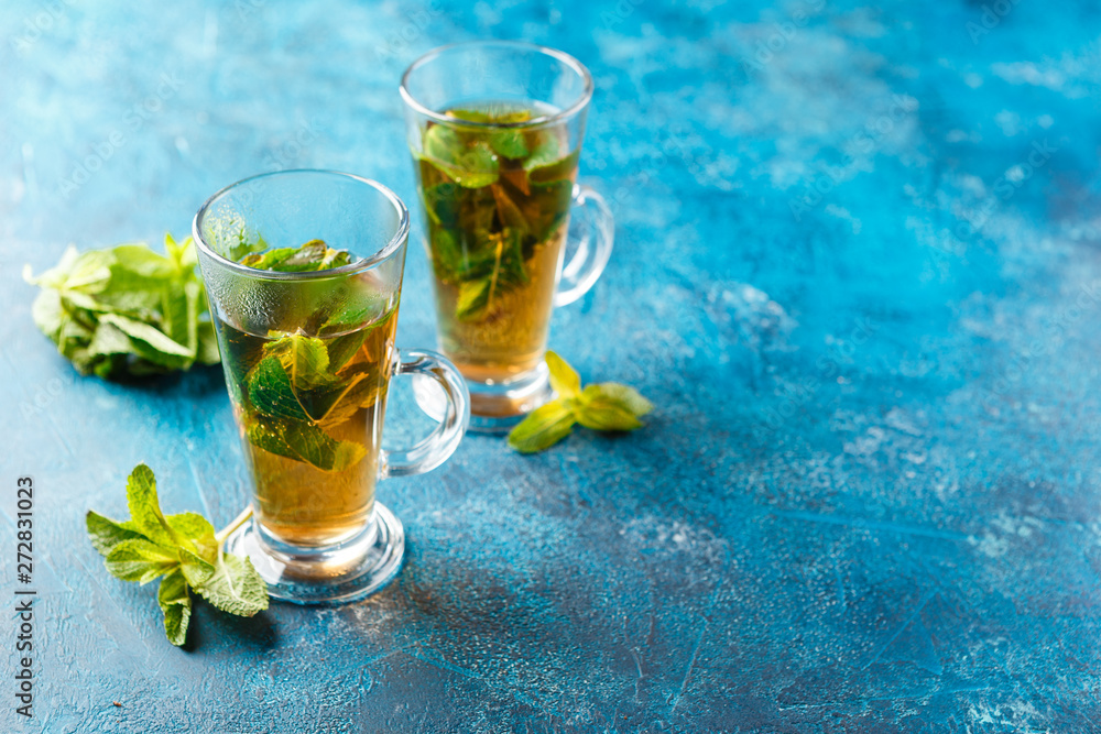 Cup of hot tea cane sugar dry tea leaves and mint herb. Cup of hot tea cane sugar dry tea leaves and mint herb.