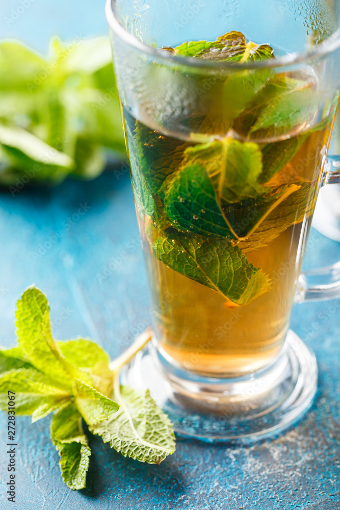 Cup of hot tea cane sugar dry tea leaves and mint herb. Cup of hot tea cane sugar dry tea leaves and mint herb.