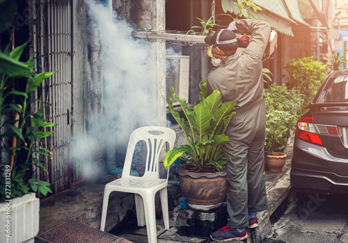 Man spraying fogging, eliminating mosquitoes, stopping the spread of dengue fever