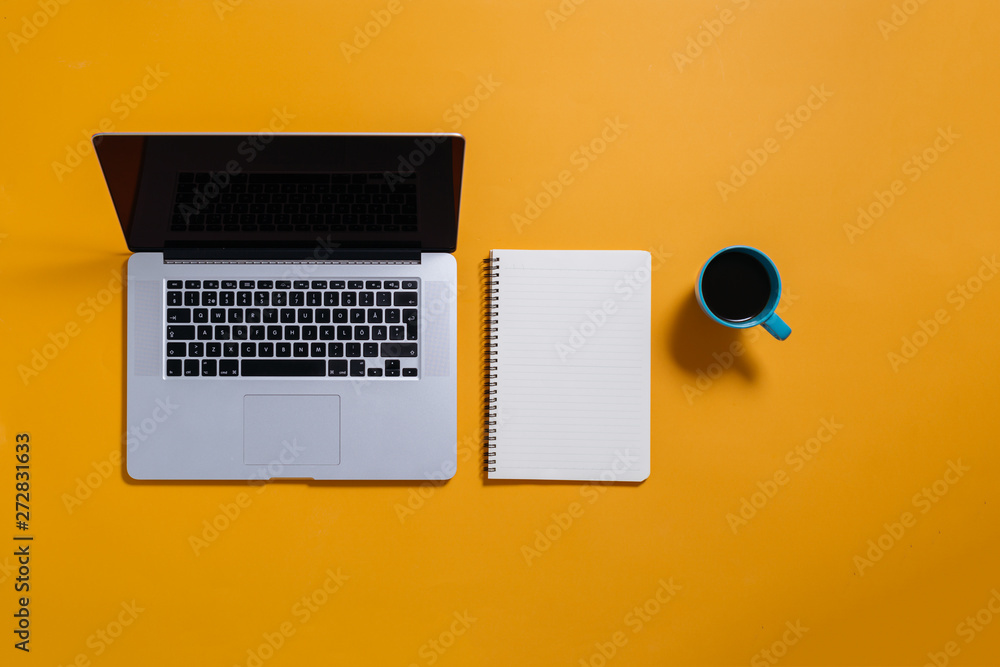 flat lay of laptop and notebook on yellow background. flat lay of laptop and notebook on yellow background.