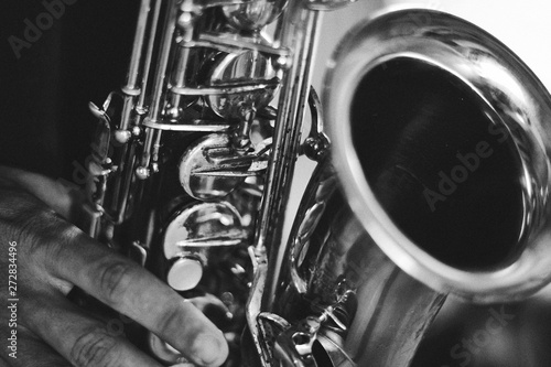 Canvas Print Black and white closeup picture of hands of a man playing saxophone