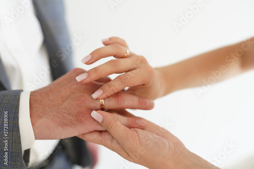 Hands of bride and groom with rings on white background. concept of love and marriage