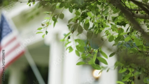 American Flag Hangs On Front Porch Of Old Southern House