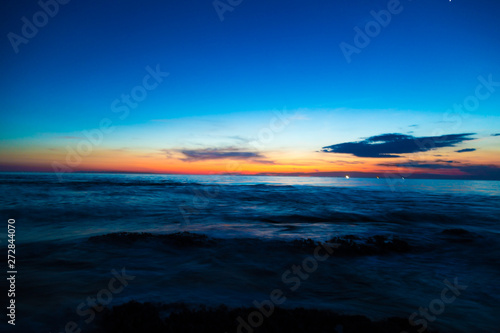 Silhouette scene of sea beach sunset with colorful sky