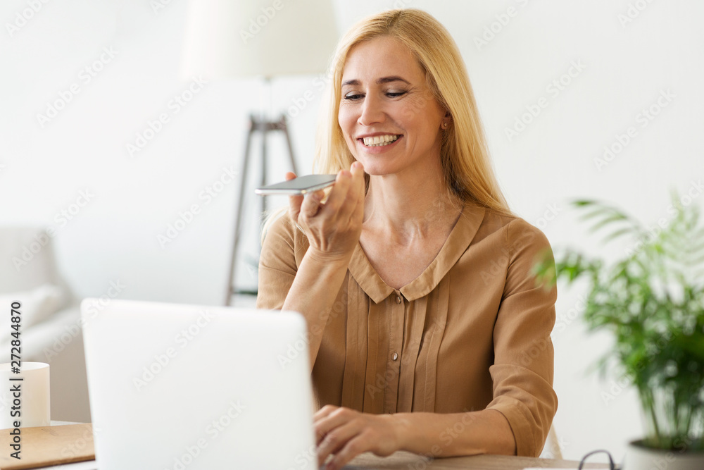 Audio Message. Woman Using Phone, Working On Laptop Audio Message. Woman Using Phone, Working On Laptop