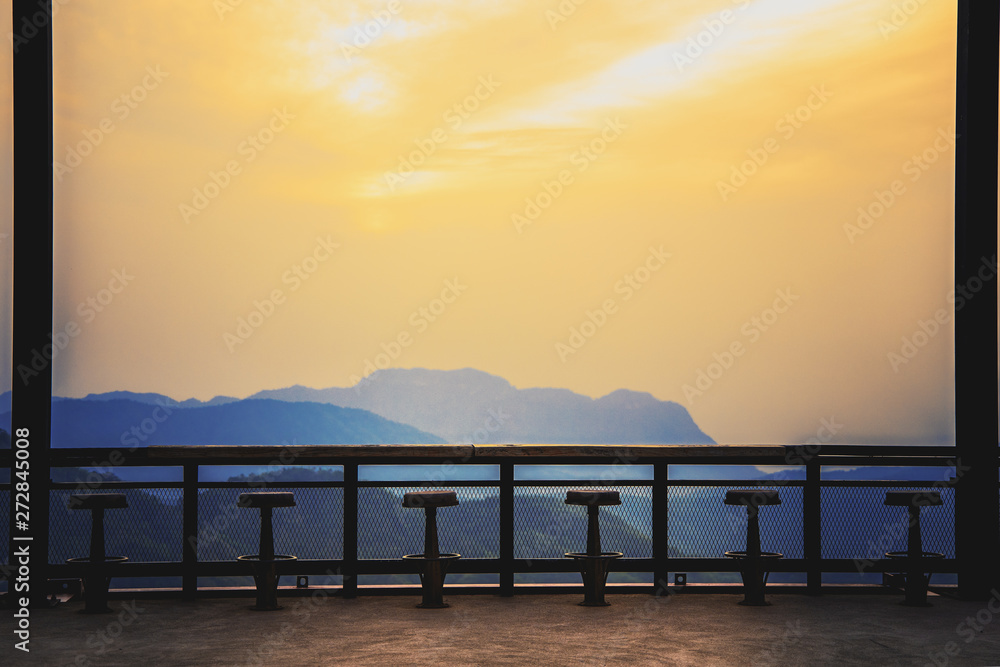 Old wooden chair with high sunrise view on the mountain Old wooden chair with high sunrise view on the mountain
