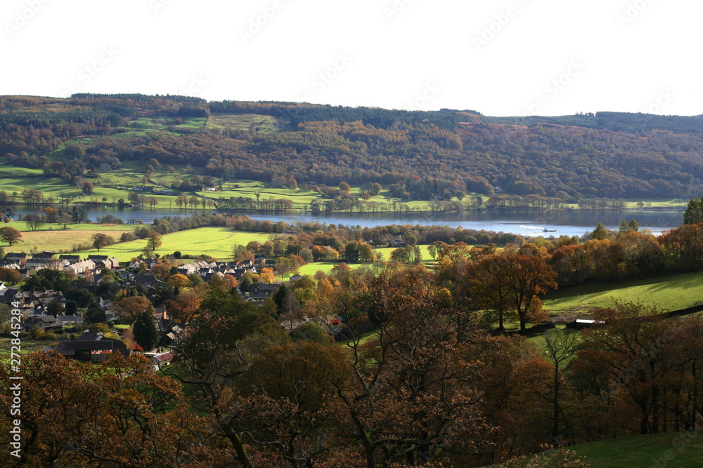 Village and Coniston Water viewed from an elevated position on the lower slope of Coniston Old Man Mountain. Village and Coniston Water viewed from an elevated position on the lower slope of Coniston Old Man Mountain.