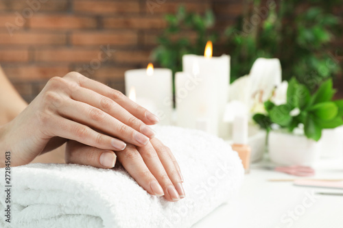 Woman showing smooth hands on towel at table  closeup with space for text. Spa treatment